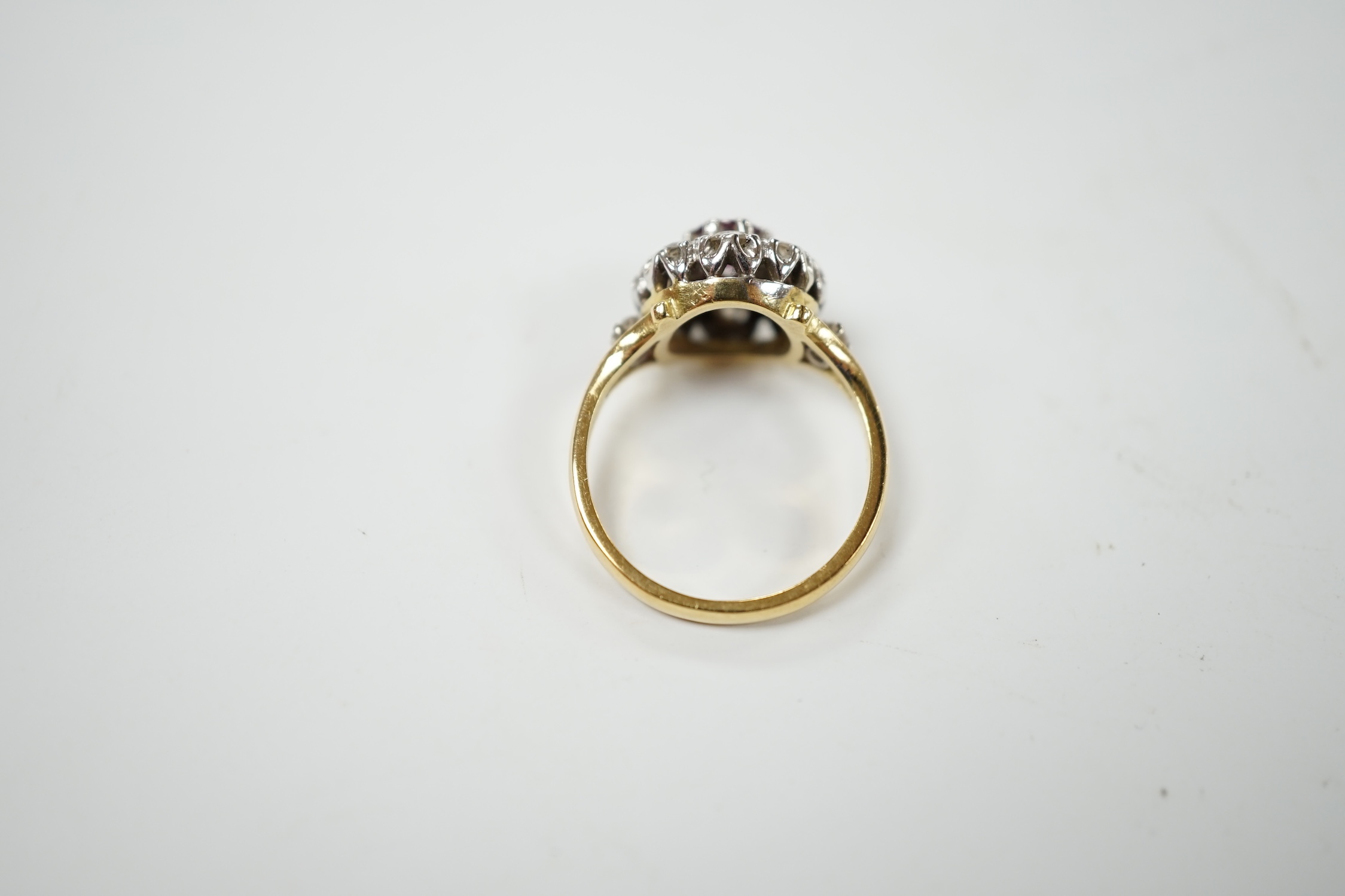 A yellow metal ruby and diamond cluster set flower head ring, size I/J, gross weight 3.6 grams. Condition - fair